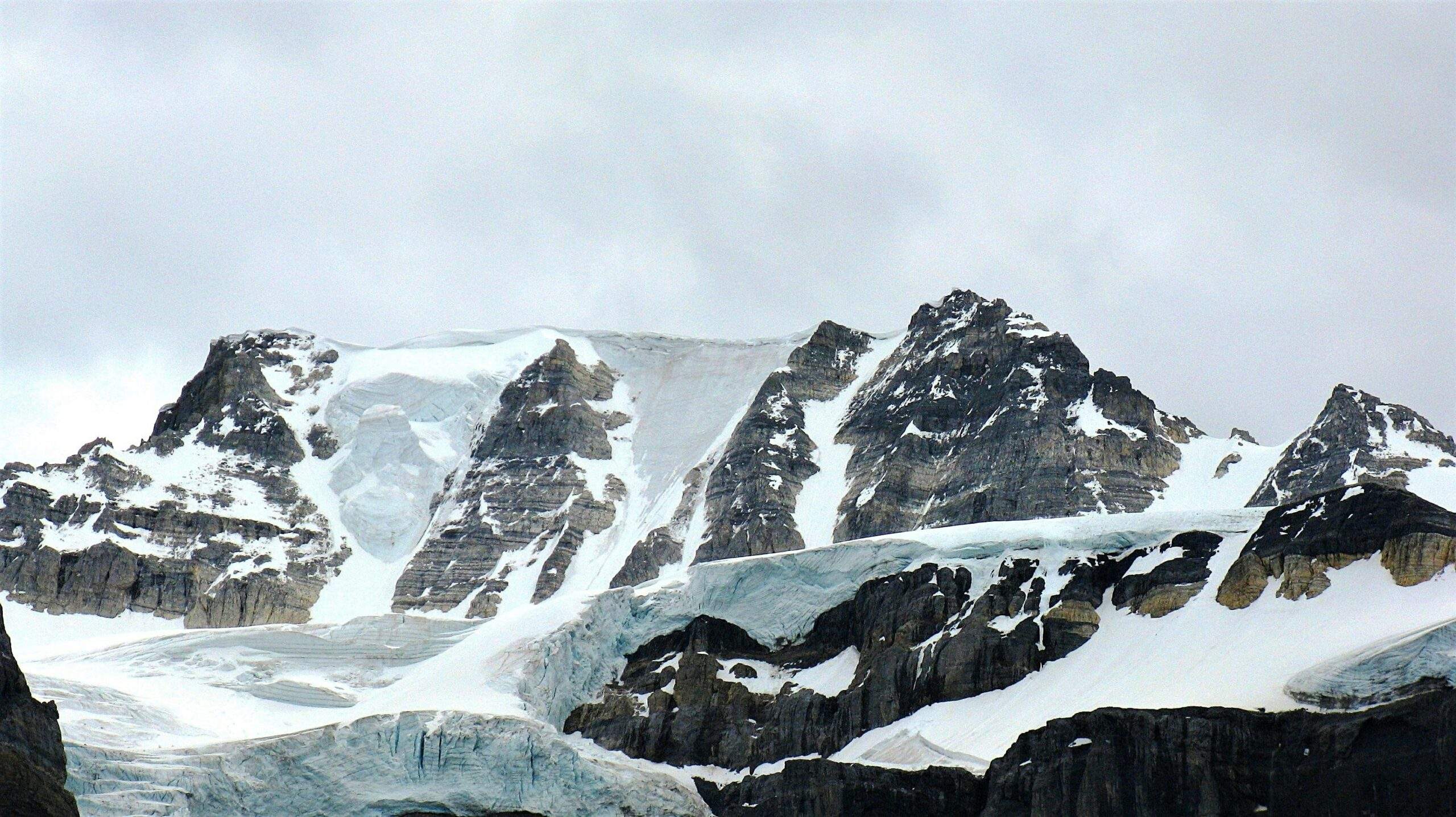 Group of People Performing Ice Climbing Near Glaciers
