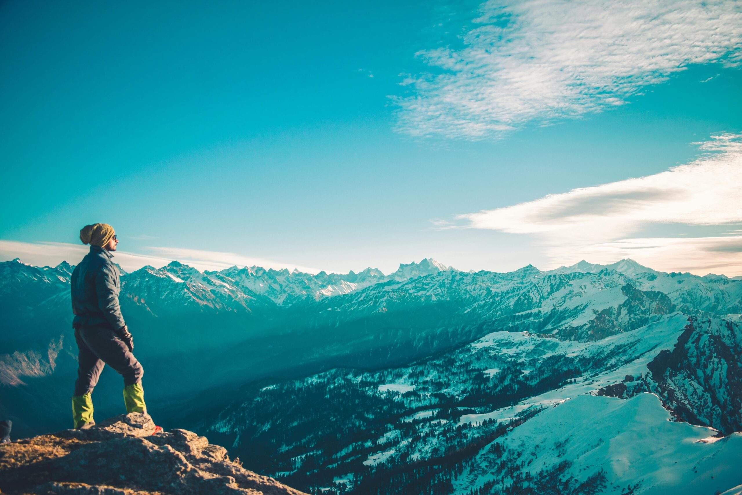 Panoramic view of snow-covered mountains under clear blue skies