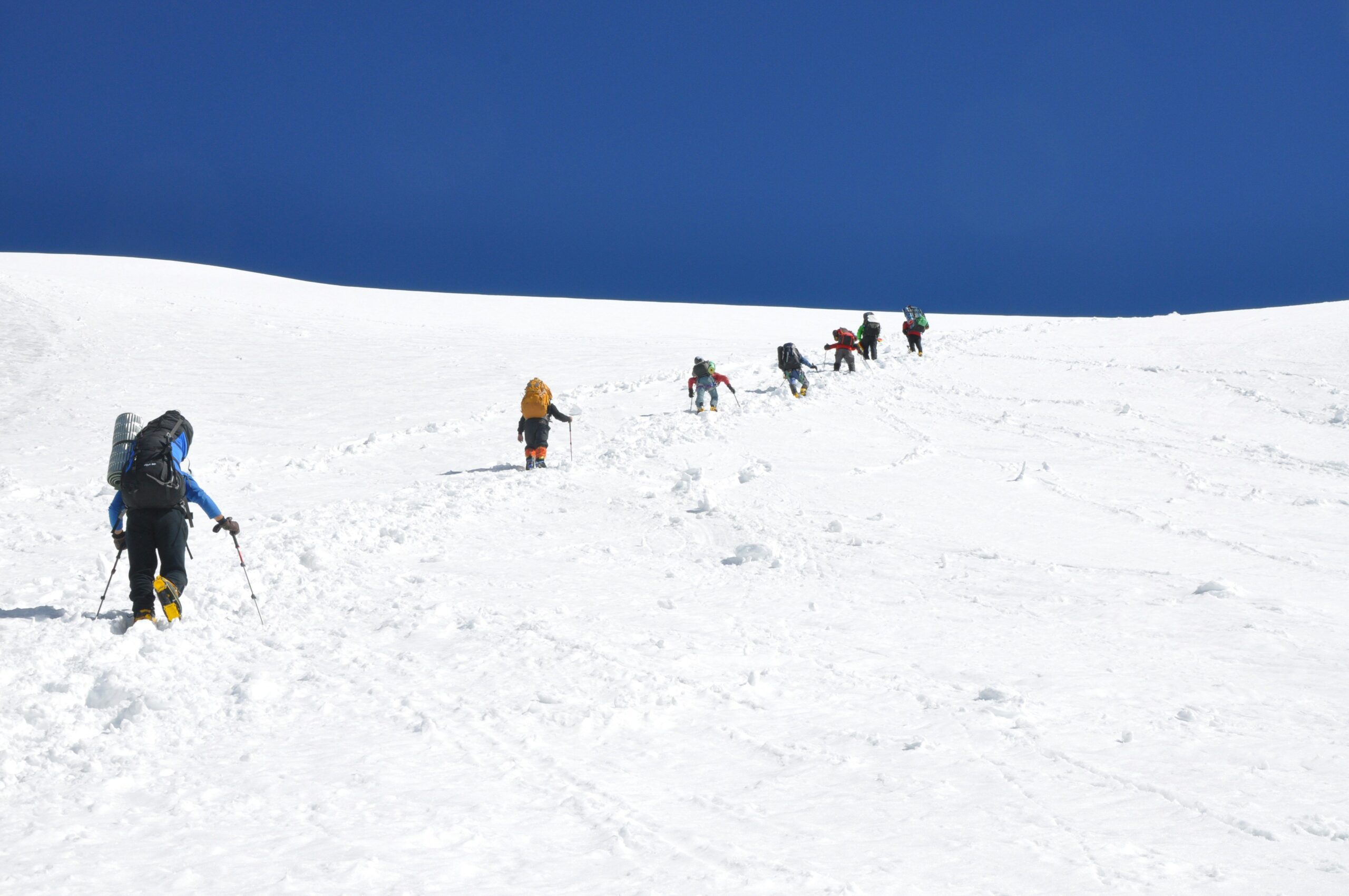 Snow-covered mountains under a bright blue sky