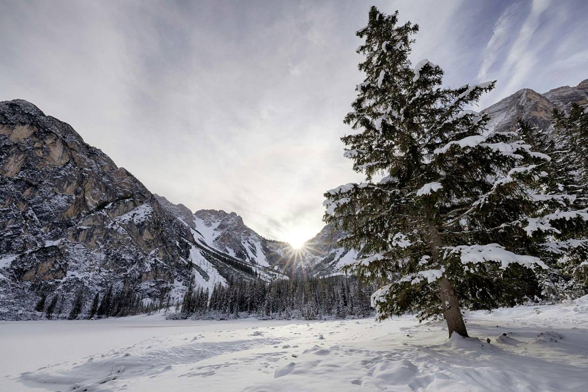 A frozen lake surrounded by snow-covered mountains