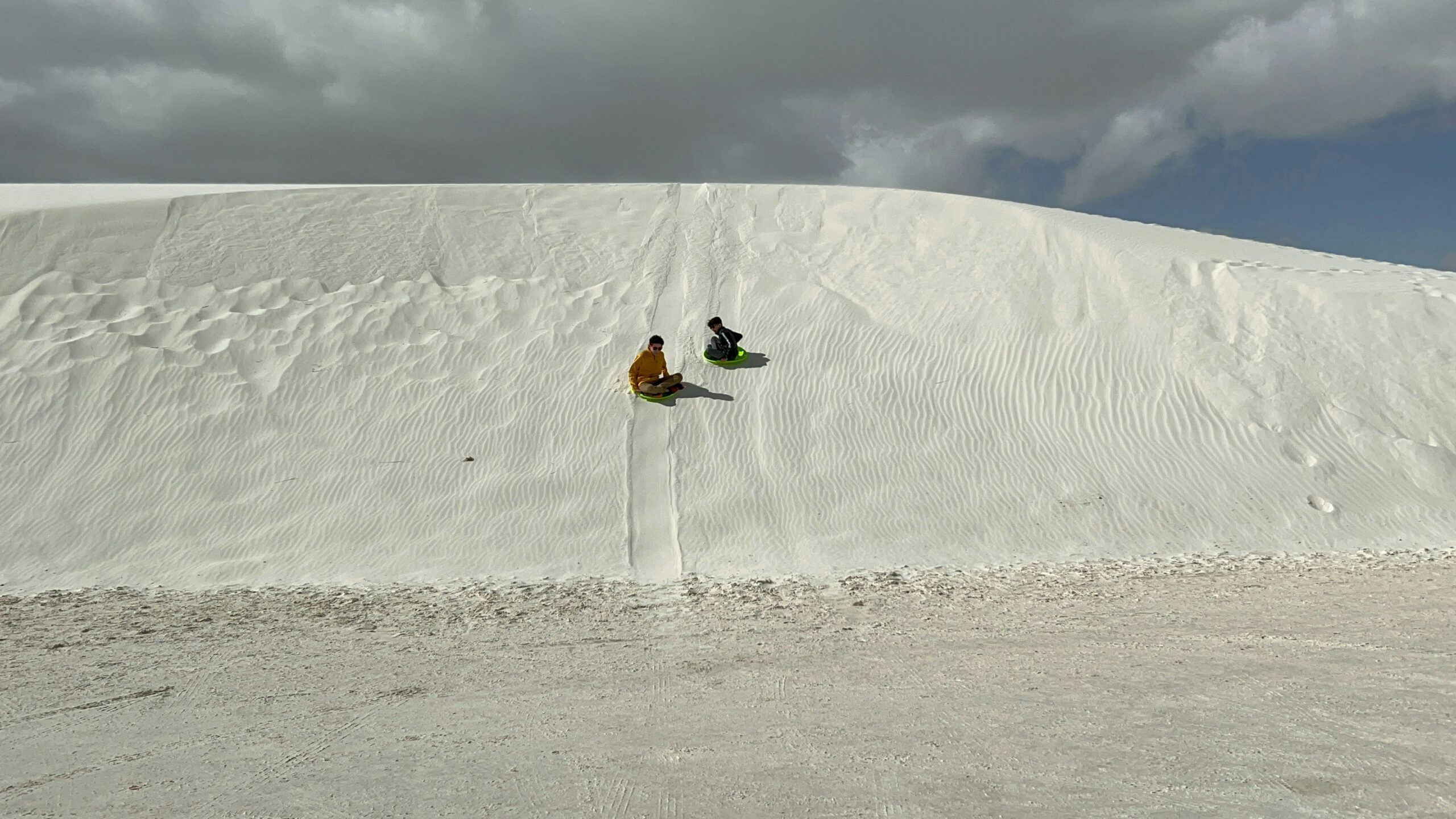 Sledding on sand in White Sands National Park