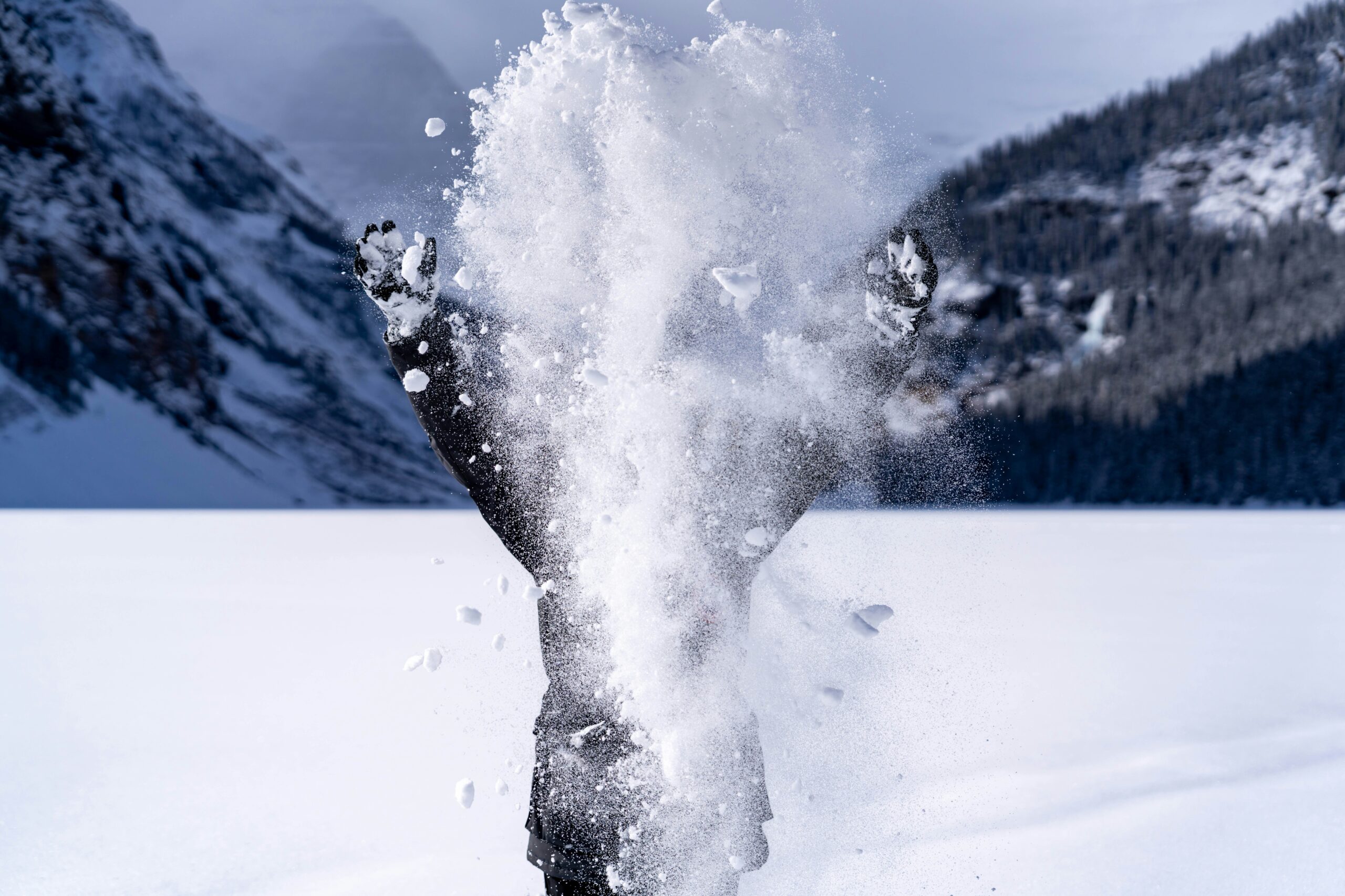 hidden person throwing snow up into the air