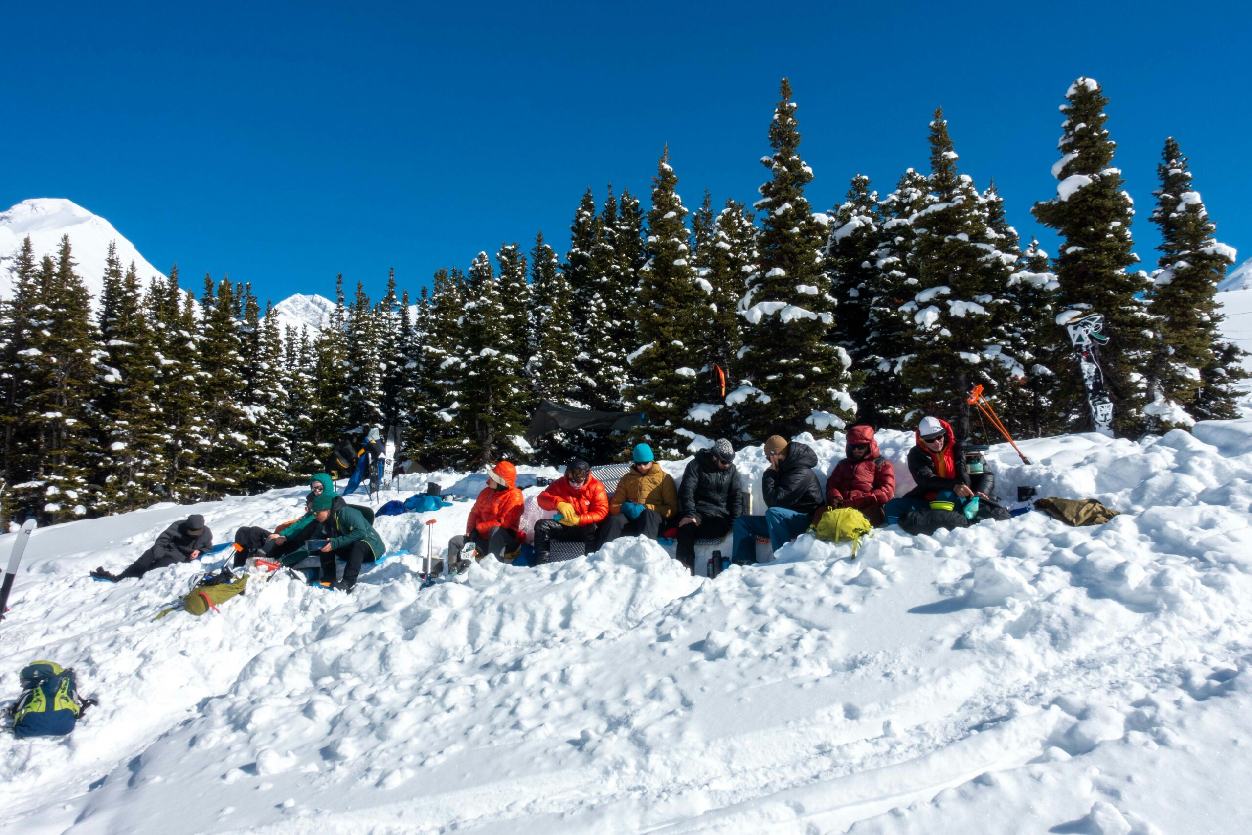 people riding on sled on snow covered ground during daytime